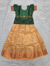 Bottle green semi silk top with antique gold bridal silk skirt pattu pavadai for girls featuring puff sleeves, waist belt detailing and double chain stone neck work by Sri Thulir Tex