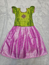 Green semi silk top with pink bridal silk skirt pattu pavadai for girls featuring puff sleeves and double chain stone neck work, traditional South Indian ethnic wear by Sri Thulir Tex