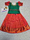 Green and red kids pattu pavadai set with puff sleeves and premium bridal silk skirt by Sri Thulir Tex