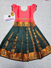 Kids Pattu Pavadai set with coral pink stone-work top and dark green zari woven skirt from Sri Thulir Tex.