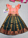 Kids Pattu Pavadai set with peach top and dark green zari woven skirt from Sri Thulir Tex.