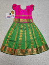 Kids Pattu Pavadai set with pink top and green zari woven skirt from Sri Thulir Tex.