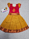 Kids pattu pavadai set with red semi-silk top and mustard gold bridal silk skirt by Sri Thulir Tex