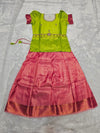 Lime green semi silk top with rose pink bridal silk skirt pattu pavadai for girls featuring puff hand sleeves, waist belt design and double chain stone neck work by Sri Thulir Tex