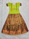 Parrot green semi silk top with antique gold bridal silk skirt pattu pavadai for girls featuring puff hand sleeves, waist belt detailing and double chain neck stone work by Sri Thulir Tex