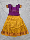 Royal purple semi silk top with mustard gold bridal silk skirt pattu pavadai for girls featuring puff sleeves, waist belt design and double chain neck stone work