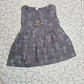 Dark grey muslin baby jabla frock with white multi print and wooden buttons for 0–6 months.