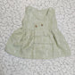 Light green muslin baby jabla frock with white multi print and button design for 0–6 months.