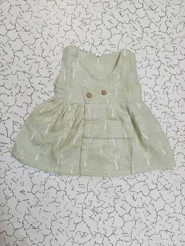 Light green muslin baby jabla frock with white multi print and button design for 0–6 months.