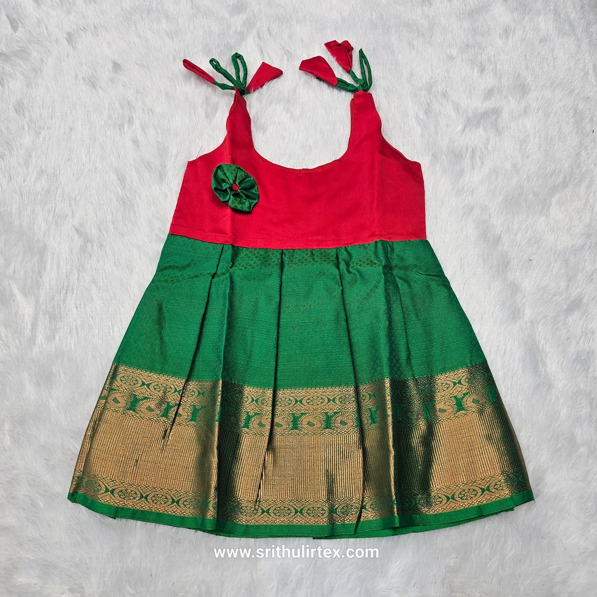 Pink top and green bridal silk baby frock with zari border by Sri Thulir Tex