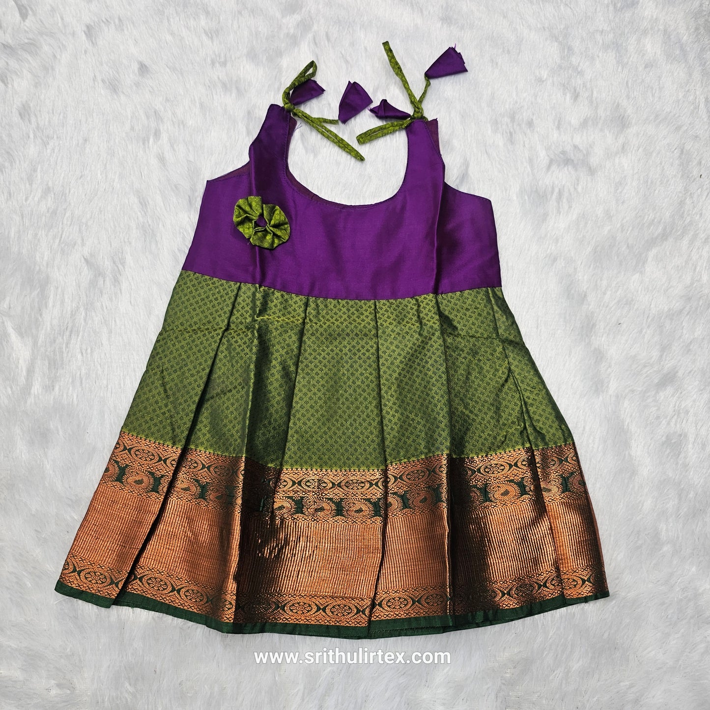 Pink top and green bridal silk baby frock with zari border by Sri Thulir Tex