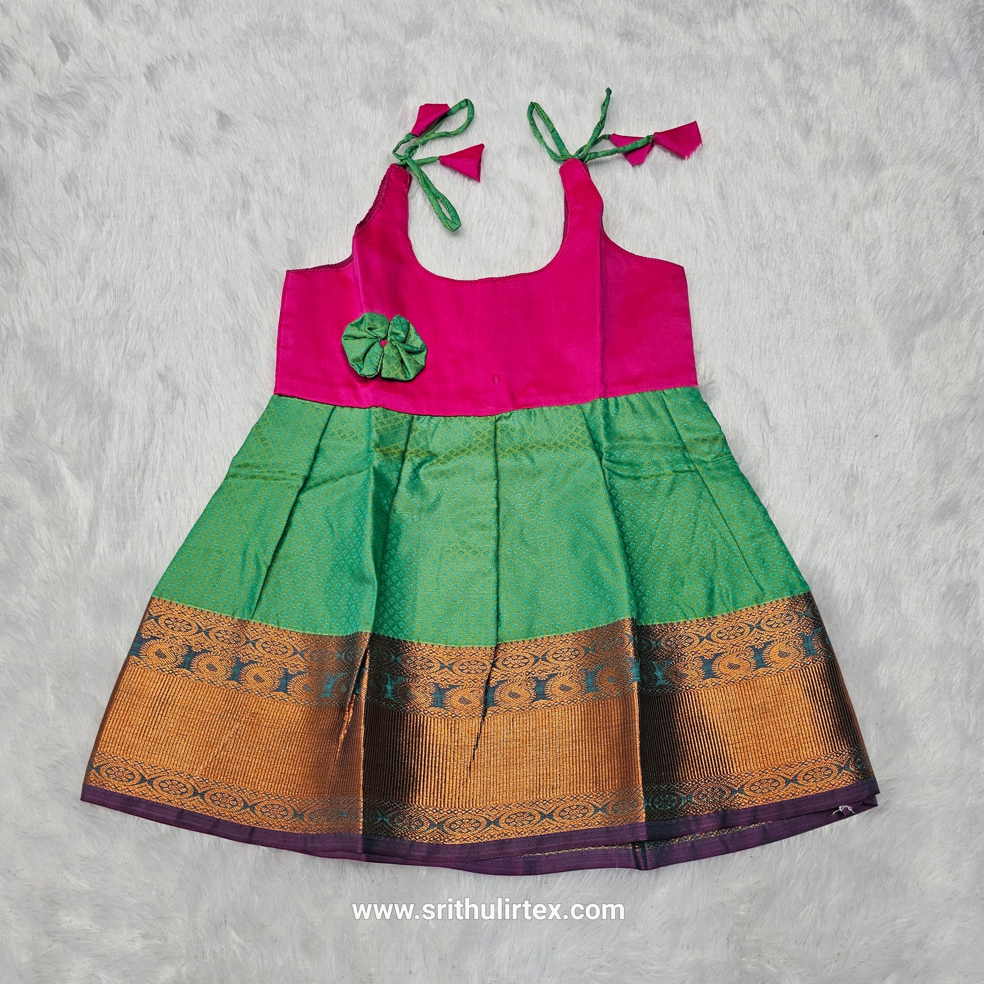 Pink top and green bridal silk baby frock with zari border by Sri Thulir Tex