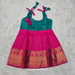 Pink top and green bridal silk baby frock with zari border by Sri Thulir Tex