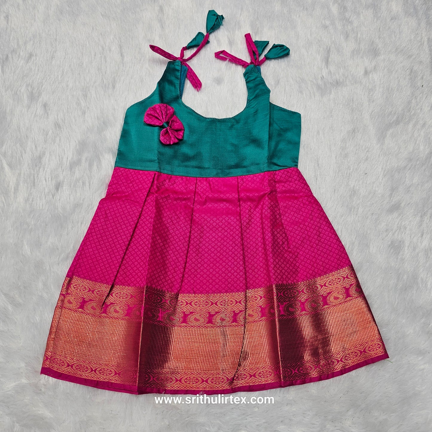 Pink top and green bridal silk baby frock with zari border by Sri Thulir Tex