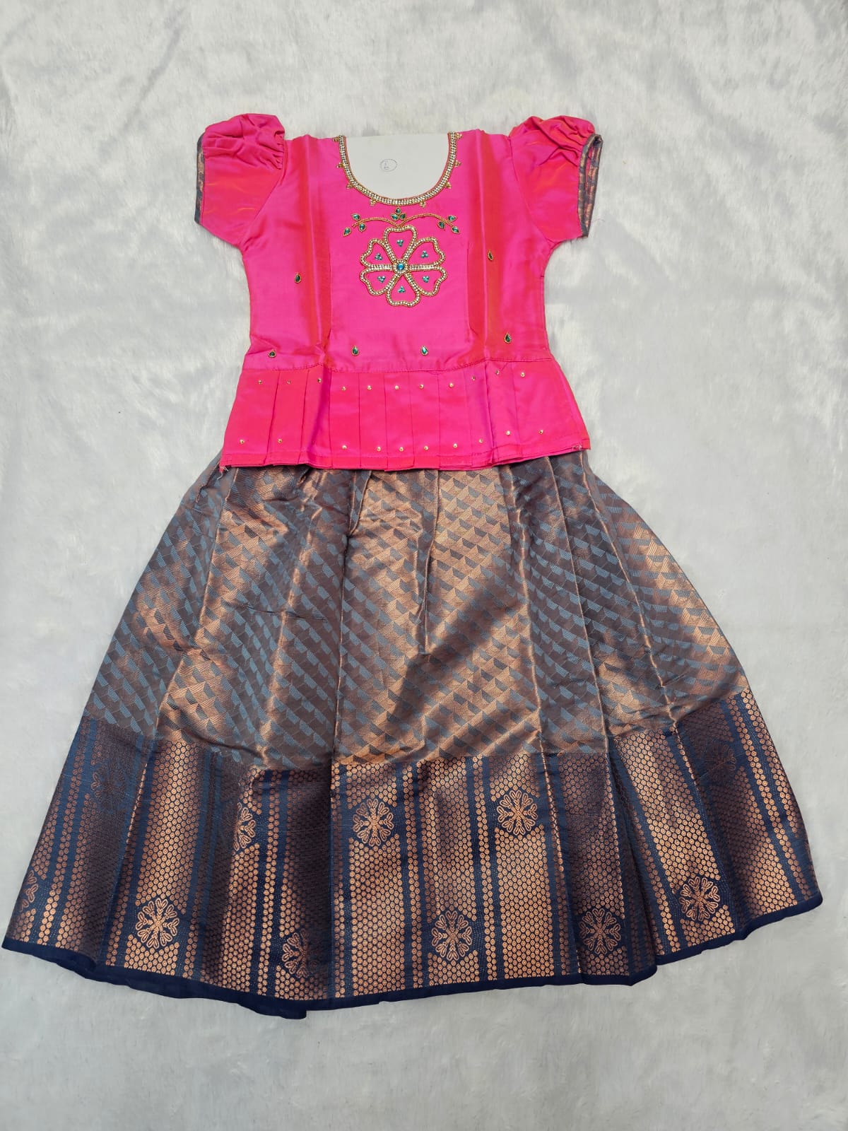 Bright pink semi silk and bridal silk pattu pavadai for girls with puff sleeves and double chain stone neck work, traditional South Indian festive wear by Sri Thulir Tex