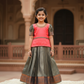 Coral pink and green kids pattu pavadai set with puff sleeves and zari bridal silk skirt by Sri Thulir Tex