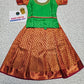 Green and copper kids pattu pavadai set with puff sleeves and bridal silk skirt by Sri Thulir Tex