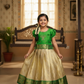 Green and golden Banarasi semi silk pattu pavadai for girls with puff sleeves and elegant zari border – Sri Thulir Tex