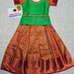 Girl wearing green top and maroon bridal silk skirt pattu pavadai – Sri Thulir Tex model photo