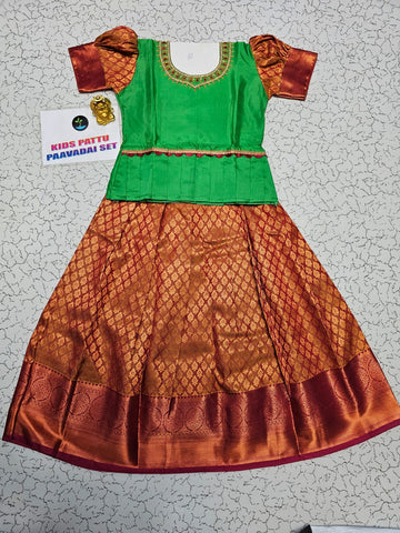 Girl wearing green top and maroon bridal silk skirt pattu pavadai – Sri Thulir Tex model photo
