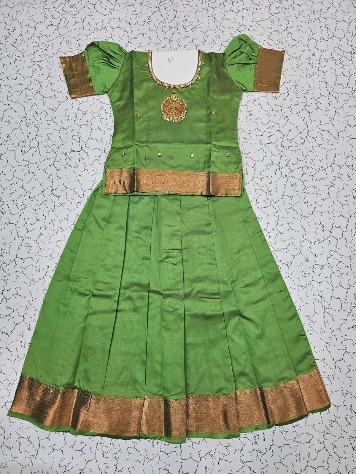 Green semi silk pattu pavadai for girls with puff sleeves and gold zari border – Sri Thulir Tex