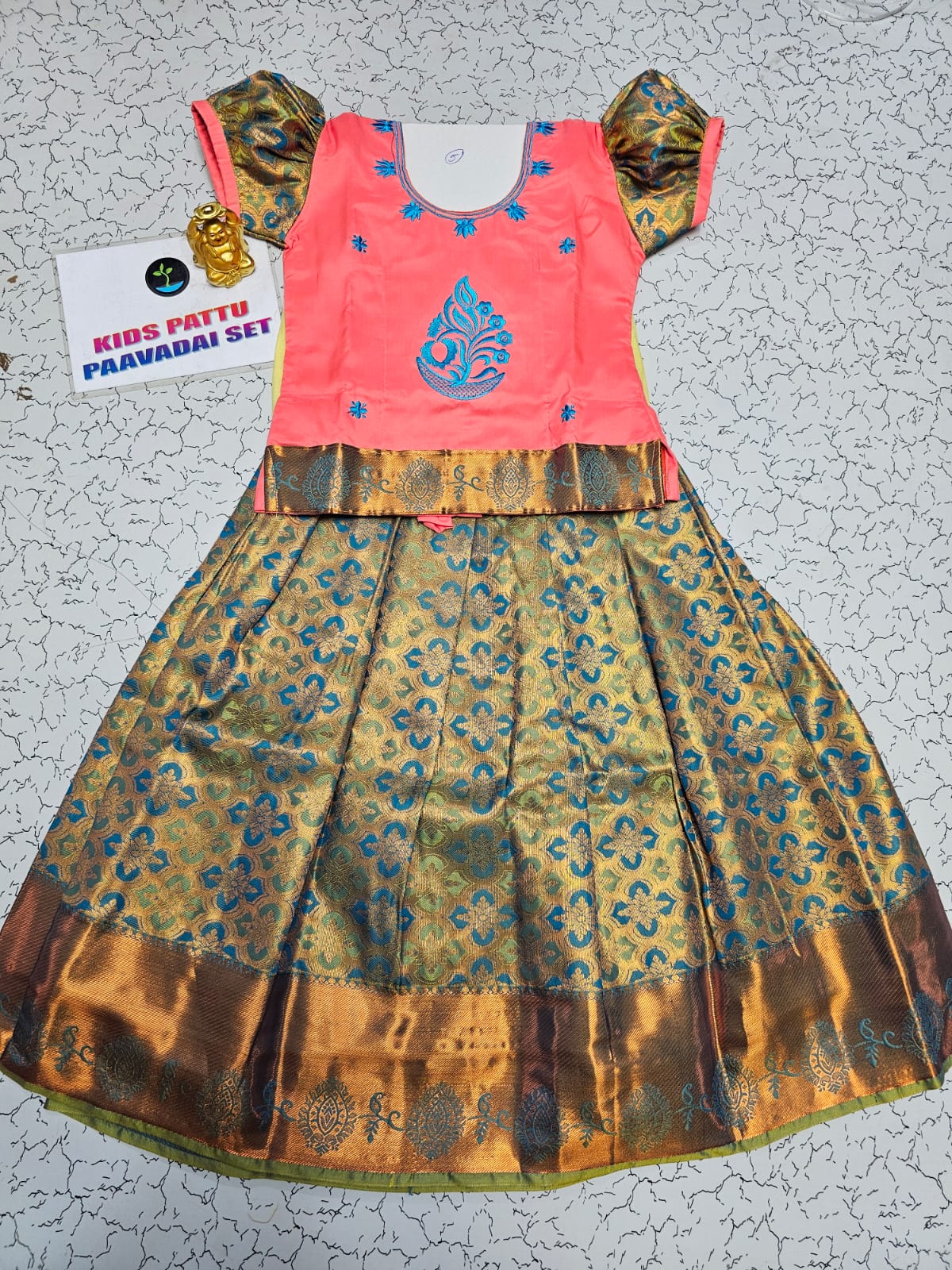 Kids pattu pavadai set with coral pink semi-silk top and teal blue bridal silk skirt by Sri Thulir Tex