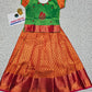 Kids green and orange pattu pavadai set with puff sleeve blouse and zari skirt from Sri Thulir Tex