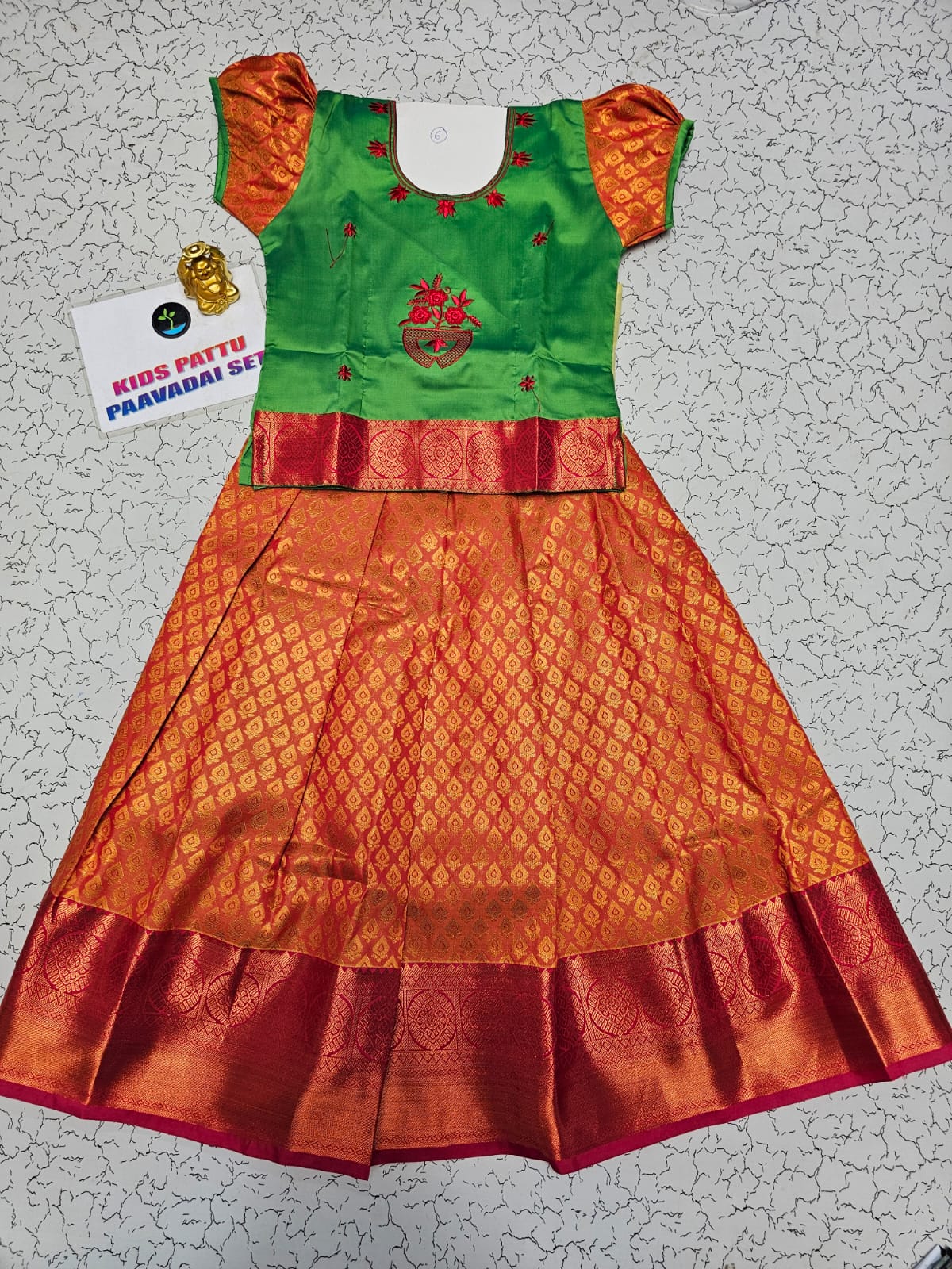 Kids green and orange pattu pavadai set with puff sleeve blouse and zari skirt from Sri Thulir Tex