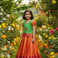Kids green and orange pattu pavadai set with puff sleeve blouse and zari skirt from Sri Thulir Tex