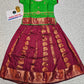 Kids Pattu Pavadai set with green top and maroon zari woven skirt from Sri Thulir Tex.