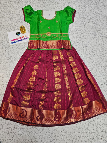 Kids Pattu Pavadai set with green top and maroon zari woven skirt from Sri Thulir Tex.