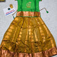 Kids Pattu Pavadai set with green stone-work top and mustard zari woven skirt from Sri Thulir Tex.