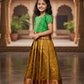 Kids Pattu Pavadai set with green stone-work top and mustard zari woven skirt from Sri Thulir Tex.