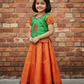 Kids pattu pavadai set with green semi silk top and orange bridal silk skirt by Sri Thulir Tex