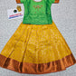 Kids pattu pavadai set with green semi silk top and yellow bridal silk skirt from Sri Thulir Tex