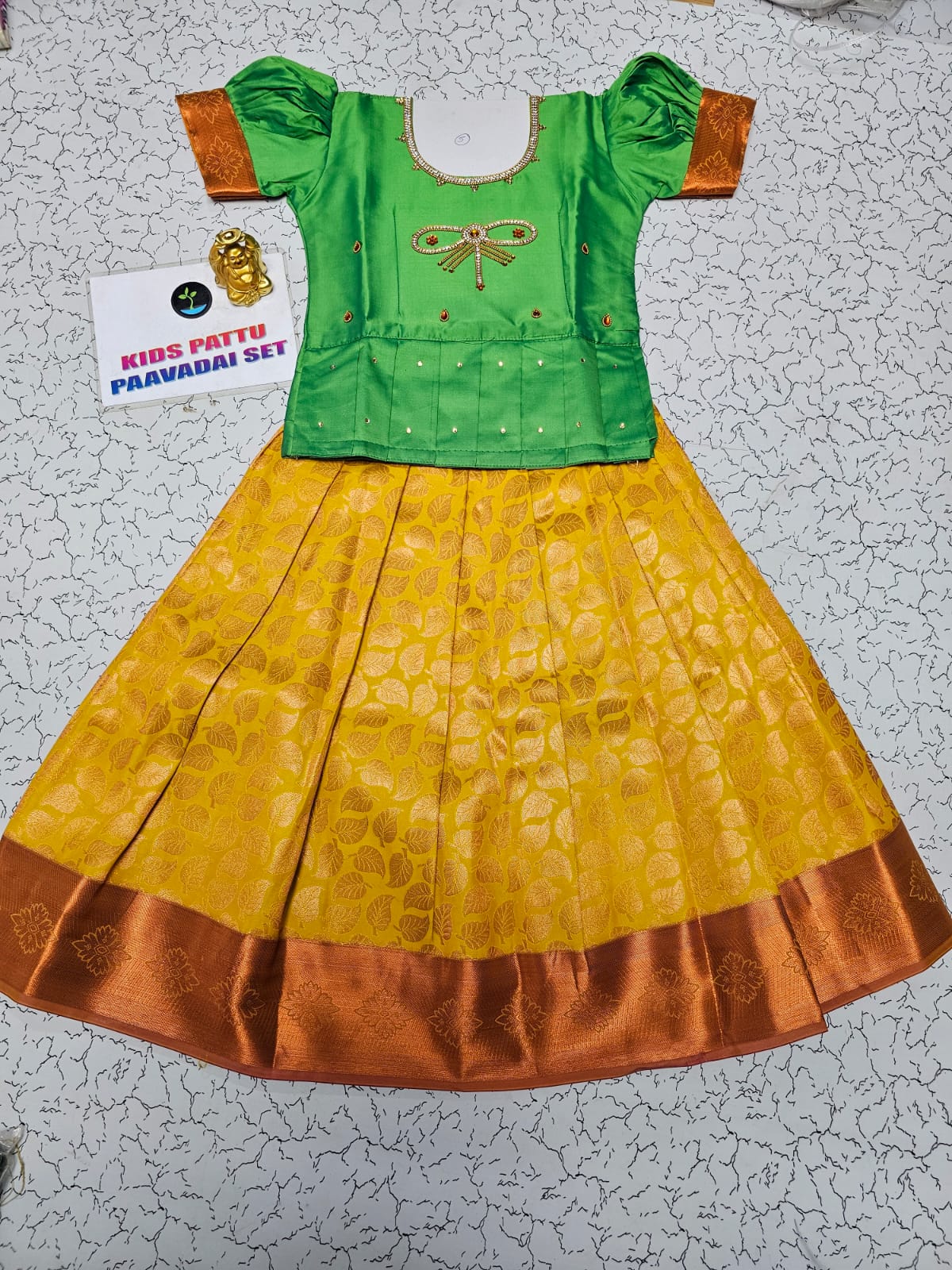 Kids pattu pavadai set with green semi silk top and yellow bridal silk skirt from Sri Thulir Tex