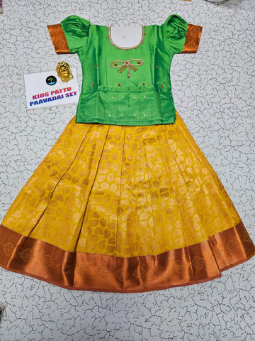 Kids pattu pavadai set with green semi silk top and yellow bridal silk skirt from Sri Thulir Tex