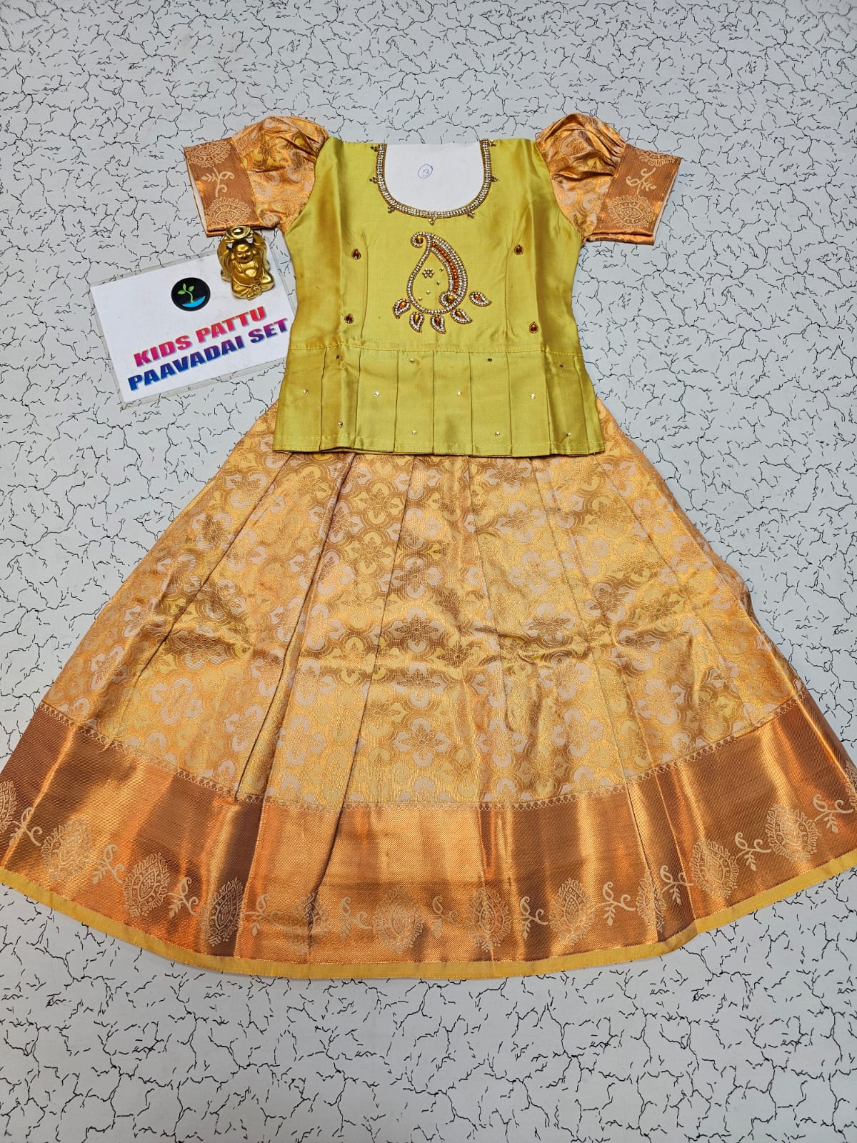 Kids pattu pavadai set with light green semi silk top and gold bridal silk skirt from Sri Thulir Tex