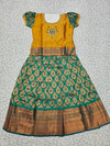 Kids pattu pavadai with mustard semi-silk top and green bridal silk skirt – Sri Thulir Tex traditional wear.