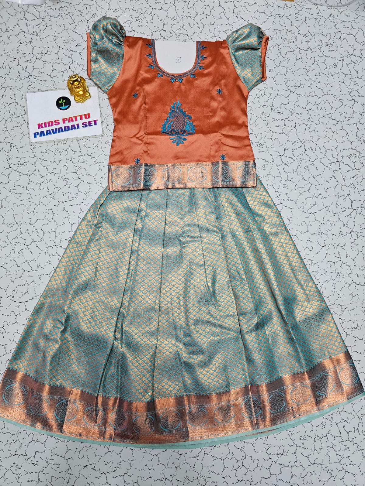 Kids orange and aqua blue pattu pavadai set with puff sleeve blouse and zari silk skirt from Sri Thulir Tex