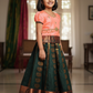 Kids Pattu Pavadai set with peach top and dark green zari woven skirt from Sri Thulir Tex.