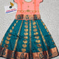 Kids Pattu Pavadai set with peach top and teal zari embroidered skirt from Sri Thulir Tex.