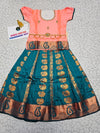 Kids Pattu Pavadai set with peach top and teal zari embroidered skirt from Sri Thulir Tex.
