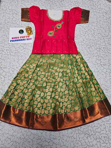 Kids pink semi-silk top with green and gold bridal silk pattu pavadai set by Sri Thulir Tex