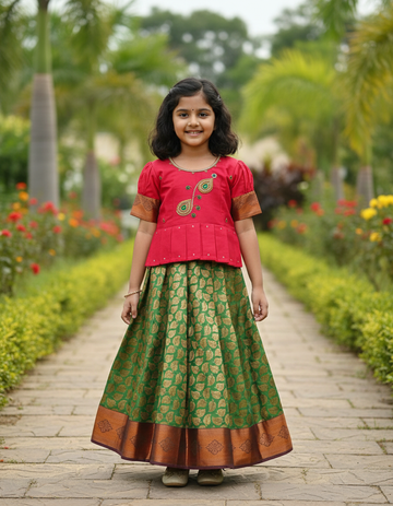 Kids pink semi-silk top with green and gold bridal silk pattu pavadai set by Sri Thulir Tex