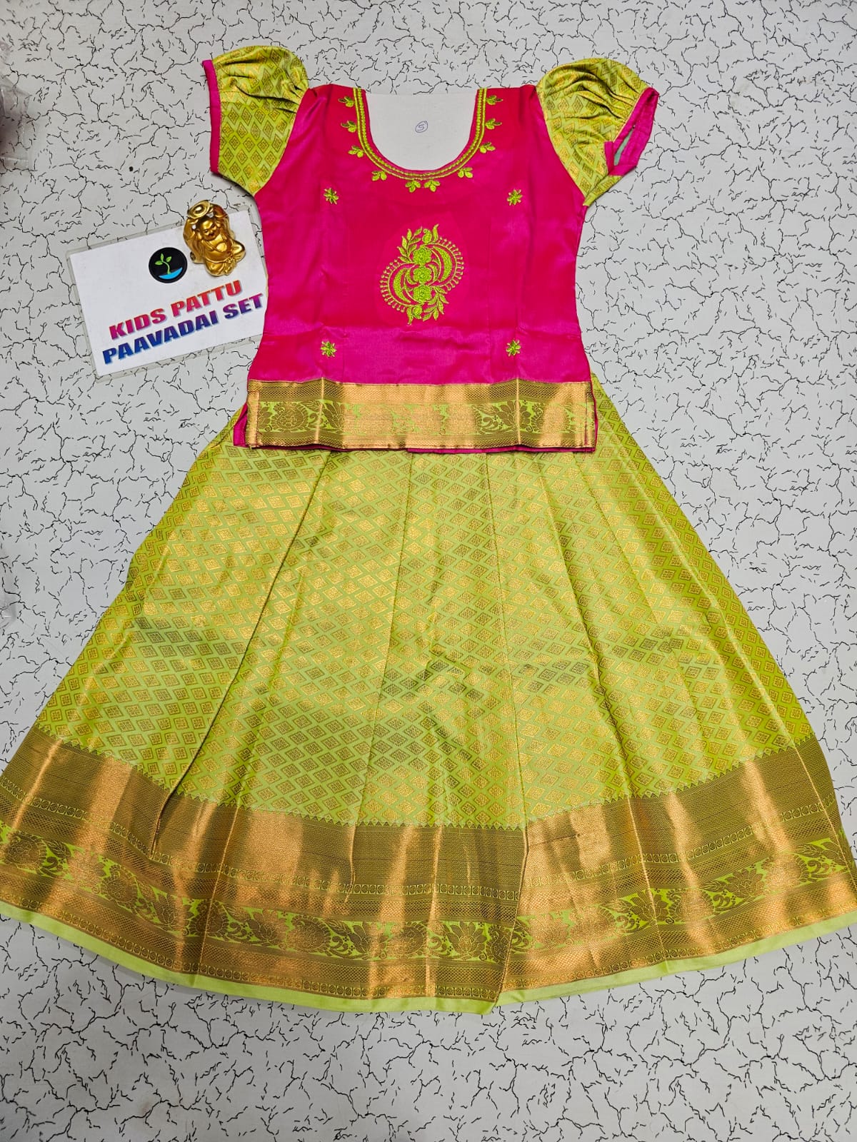 Kids pink and lemon green pattu pavadai set with puff sleeves and zari woven silk skirt from Sri Thulir Tex