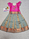 Kids Pattu Pavadai set with pink top and light green zari woven skirt from Sri Thulir Tex.