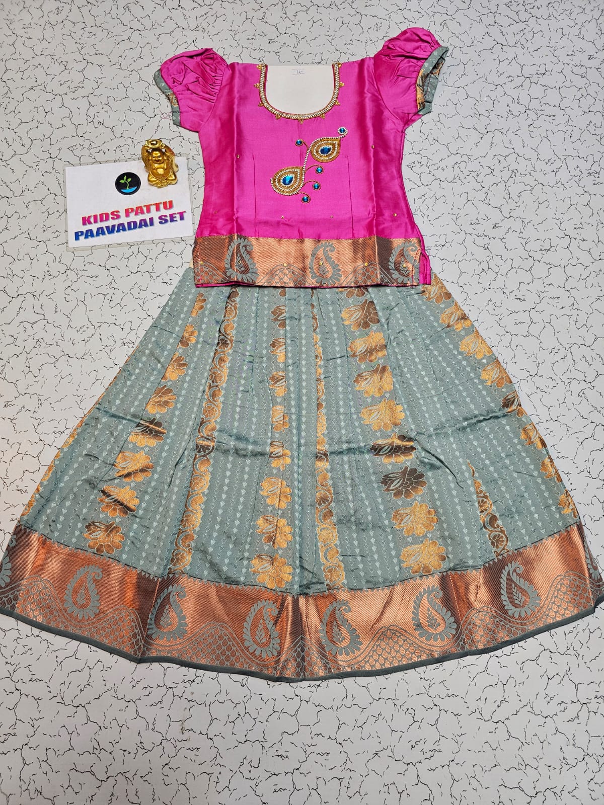 Kids Pattu Pavadai set with pink top and light green zari woven skirt from Sri Thulir Tex.
