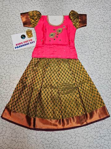 Kids Pattu Pavadai set with pink stone-work top and mustard green zari woven skirt from Sri Thulir Tex.