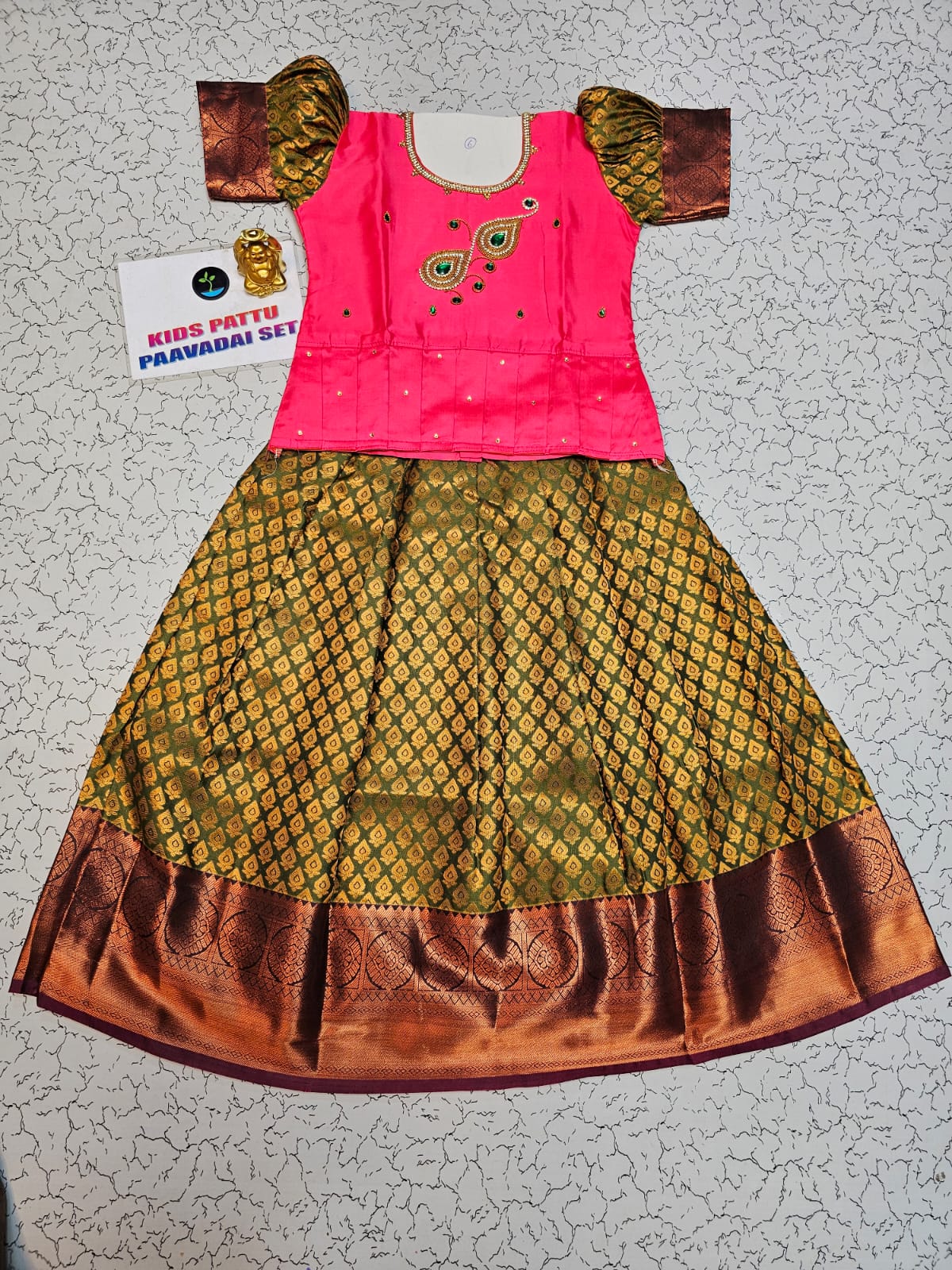 Kids Pattu Pavadai set with pink stone-work top and olive green zari woven skirt from Sri Thulir Tex.